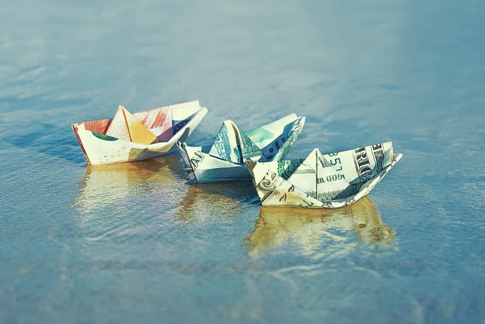 dollar bill origami boats in water
