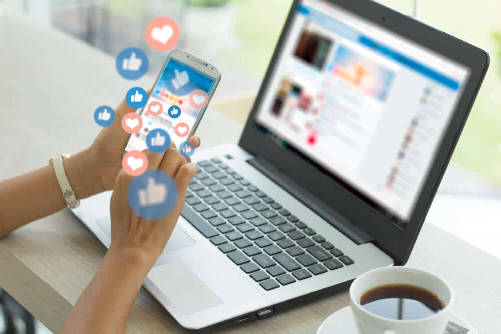 Laptop nad smartphone showing social media engagement