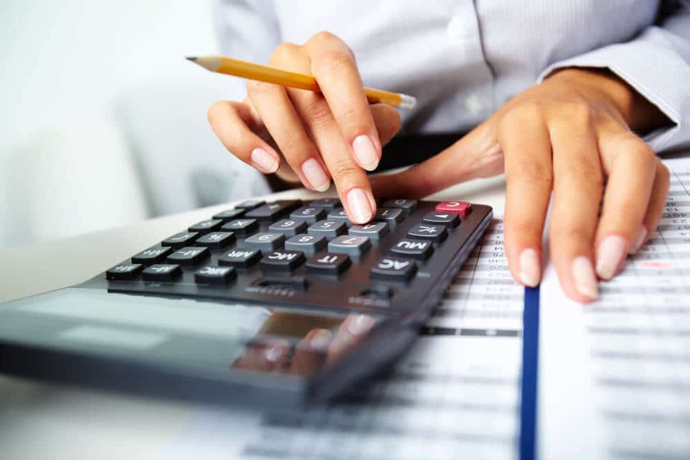 Woman using a calculator for small business accounting